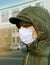 Man in respirator in urban scape, pandemic virus protective mask, air pollution problem