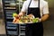 Man in restaurant holding plate with colorful healthy finger food