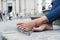 Man resting barefoot on the street