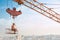 Man resting on construction on high and eating.