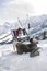 Man Resting On Deckchair In Snowy Mountains