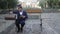 Man in retro suit and top hat pulls out book from his bag