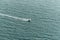 Man ridding jet ski on the sea with splashing water trace on the sea surface near Pattaya beach in Chon Buri, Thailand