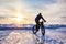 Man ride bicycle on the frozen lake