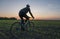 Man ride a bicycle in sunset. Riding a Bicycle at Sunset. Healthy Lifestyle Concept. Male ride bicycle in sun set. Biker