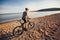 Man ride mountain bike on the beach.