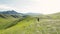 Man ride mountain bike at the green hill in the mountain of Kazakhstan