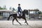 Man rider and black stallion horse galloping during equestrian dressage competition