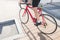 A man rides around the city on a red bike. Traveling around the city on a bicycle