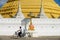Man rides bicycle in front of the Wat Chumphon Khiri Buddhist stupa in Mae Sot, Tak province, Thailand.