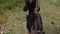 A man rides a horse top view. A riding horse goes on the farm.