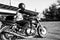 Man rides a motorcycle in the city.Motorcyclist riding a bike during the day on the road.Black and white photo