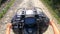 Man rides a quad bike or ATV. POV, view from above.