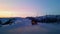 Man rides sidecar motorcycle on snowed and frozen road during dawn in Norway. There is little sideway skidding.