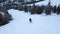 Man rides snowboard on snowbound slope among trees