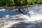 A man rides a water scooter along the Vuoks River