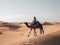 A man riding on the back of a camel in the desert. Generative AI image.