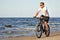Man riding bicycle in beach