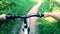 Man riding bicycle on dirt path in forest on sunny summer day. Person cycling