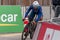 Man riding a bicycle down a lane during a competition