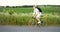 Man Riding Bicycle on Field Road