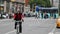 Man riding bicycle in NYC, Manhattan. Traffic and Public Transport in Blurry Background