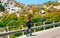 Man riding bicycle on road at rocks at Capo Testa reflex