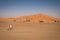 Man riding on a bike in Hassilabied, desert village in Morocco.