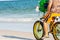 Man Riding a Bycicle on White Sand on Blur Ocean Water Background. Destin Beach, Florida