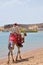 Man riding camel along beach