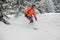 Man riding down the hill between snowcovered trees