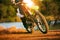 Man riding enduro motorcycle on dirt field