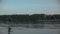 Man riding a hydrofoil surfboard on large lake at golden sunset sitting on knees