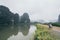 Man riding motorcycle among limestone mountains in Ninh Binh province, Vietnam