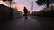 Man Riding Onewheel in Suburban Neighborhood Alley. Sunset, Fall Season.