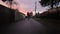 Man Riding Onewheel in Suburban Neighborhood Alley. Sunset, Fall Season.