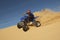 Man Riding Quad Bike In Desert