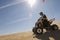 Man Riding Quad Bike In Desert