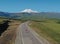 Man Riding on skateboard on Road to Elbrus, Highest Mount in Europe.