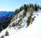 A man riding skis down the side of a snow covered mountain