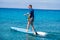 Man riding SUP stand up paddle on vacation