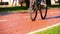 Man Riding an Three-wheeled Electric Scooter on Bike Path in the Park. Slow Motion