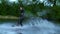 Man riding wakeboard on motorboat wave. Rider in training wake boarding