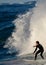 A man riding a wave on a surfboard in the ocean