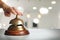 Man ringing hotel service bell on background, closeup. Space for text