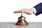Man ringing hotel service bell at stone table