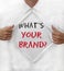 Man ripping his shirt off with a what\'s your brand text printed on his t-shirt