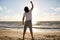 Man with rised fist on beach