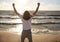 Man with rised fist on beach