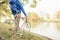 Man with road bike looking at river view in park